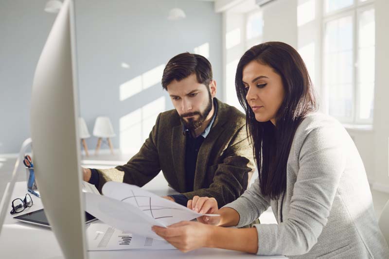 Two people using a computer