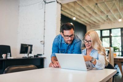 Two people using a computer